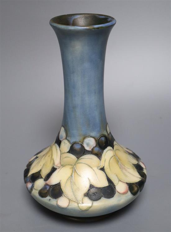 A Moorcroft matt glazed leaf and berry bottle vase, c.1930, 20.5cm high